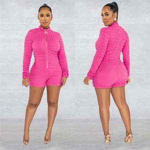 Detail of rose red bubble textured long sleeve romper with front metal zipper closure