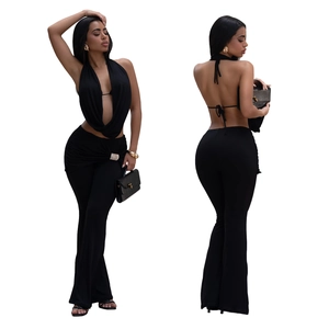 Detail view of black halter backless top and flared trousers with rhinestone waist buckle