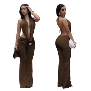 Detail of dark brown backless halter top with rhinestone buckle and flared trousers
