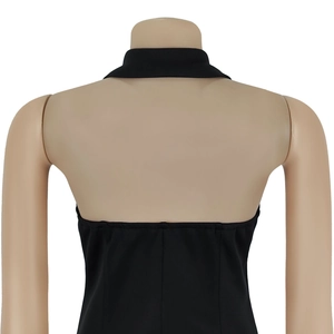 Back view detail of a black backless halter dress with premium textured fabric on a mannequin