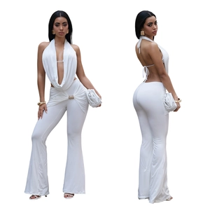 Detail of white halter backless top and flared trousers with rhinestone buckle waist