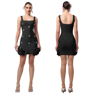 Détail de robe courte noire élégante avec accents de strass et ourlet à fleurs en relief
