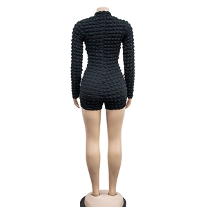Rear view of black long sleeve romper featuring honeycomb textured fabric and slim fit