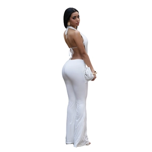 Detail of white backless halter top and flared pants set with high waist fit