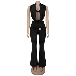 Detail of deep V-neck halter jumpsuit with gold rhinestone buckle and pleated waist