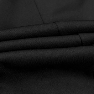 Close-up of high-quality black knitted fabric texture showing fine weave and soft matte finish