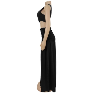 Side view of black sleeveless crop top and high waist long skirt on a mannequin