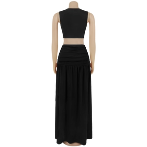 Back view of a sleek black two-piece set featuring a cropped top and a long ruched skirt