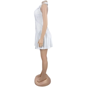 Detail of white sleeveless mini dress with blazer collar and pleated hem on mannequin