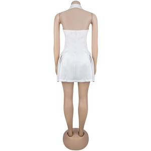 Detail of white halter dress featuring open back design with central buttons and pleats