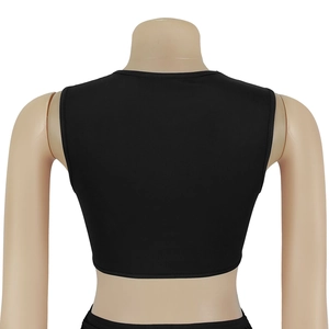 Detail of a black sleeveless crop top with a slim fit and smooth knitted texture on mannequin