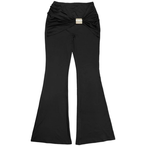Detail of high waisted black flare pants with waist pleats and a gold buckle decoration