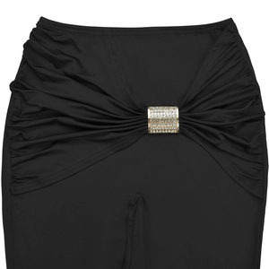 Detailed close-up of black high-waisted pants with ruching and crystal gold buckle