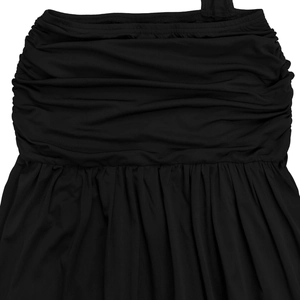 Detailed close-up of the ruched black fabric texture and pleats on the mini dress