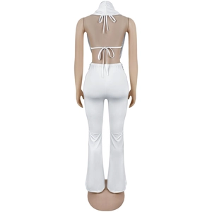 Detail view of the backless halter top and high-waisted flared trousers set in white