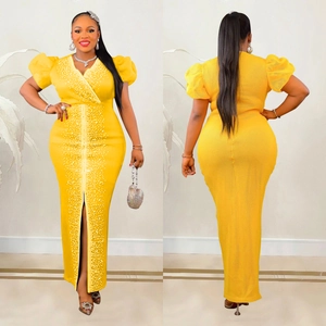 Dettaglio del vestito lungo giallo con scollo a V, maniche a sbuffo e ricami di perle