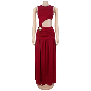 Detail of wine red bodycon dress featuring side cutout and gold shell pendant accent