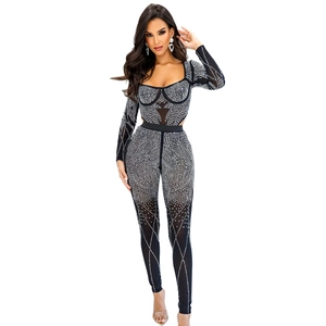 Close-up of geometric rhinestone patterns on a sleek black long-sleeve jumpsuit