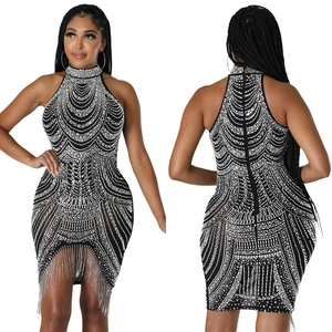 Detail view showing rhinestone patterns and silver fringe on black halter dress