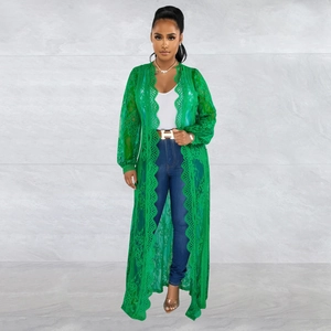 Detail view of emerald green lace cardigan featuring intricate wavy scalloped edges