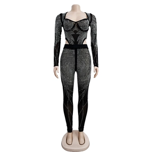 Detailed view of black mesh jumpsuit featuring intricate silver rhinestone patterns and heart neckline