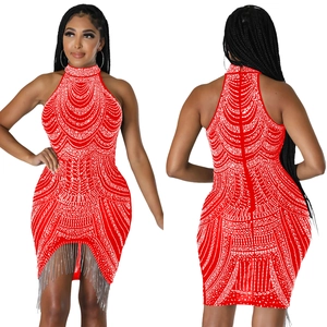Macro view of red bodycon halter dress with rhinestone patterns and metallic fringe details