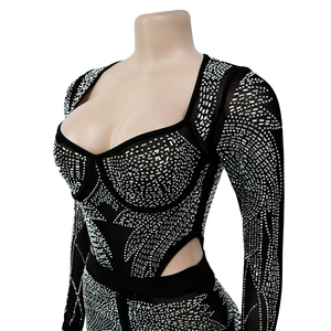 Detail of black mesh jumpsuit featuring silver rhinestones and sexy side cut-out design