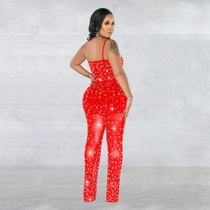 Detail of red mesh jumpsuit with sparkling rhinestones and delicate thin straps