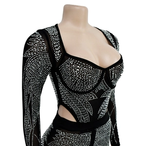 Detail of black mesh jumpsuit with silver rhinestones and heart-shaped neckline
