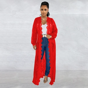 Detailed macro view of the intricate red floral lace pattern and wavy hemline on the cardigan