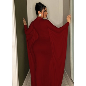 Detail of elegant red maxi dress featuring dramatic floor-length batwing cape sleeves