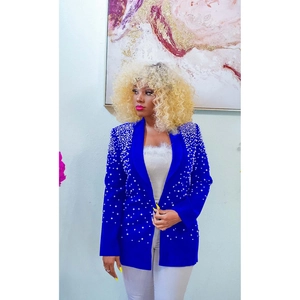 Detail shot of royal blue blazer featuring white pearl embellishments and wide lapels