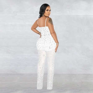 Detail shot of white sleeveless jumpsuit featuring sparkling silver rhinestones