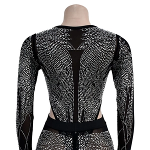 Detail of black mesh jumpsuit with silver rhinestones and open back design
