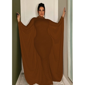 Detail of elegant brown maxi dress featuring long cape sleeves and floor-length hem