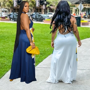 Detailed back view of backless halter maxi dresses with vibrant floral prints and floor length