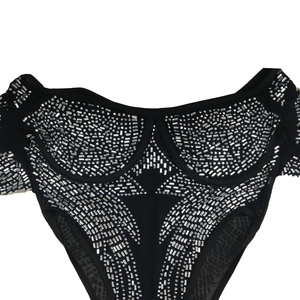 Detail of black jumpsuit with shiny silver rhinestones in geometric pattern