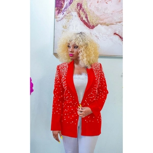 Close-up of red long blazer featuring elegant white pearl bead embellishments on shoulders