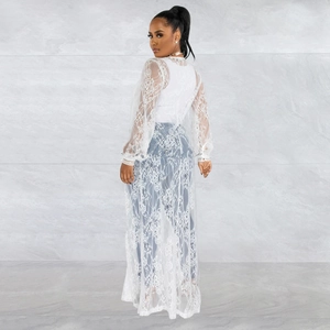 Rear view of long white lace cardigan featuring lantern sleeves and floral patterns