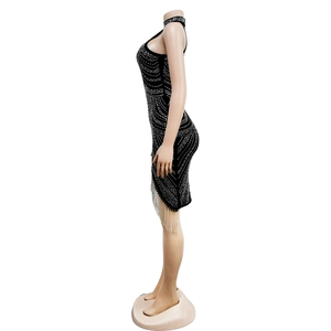 Detail of black halter mini dress with sparkling silver rhinestones and long fringe hemline