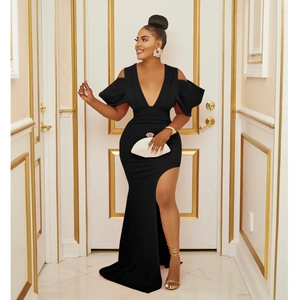 Détail d'une robe de soirée noire à col en V, manches bouffantes et fente latérale haute