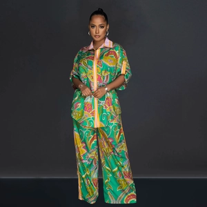 Detail of green floral paisley print fabric on the silky short sleeve shirt and wide leg pants