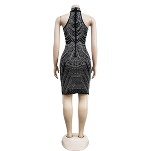 Detailed back view of a sleeveless black bodycon dress with intricate silver rhinestone patterns