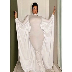 Detail of elegant white bodycon maxi dress featuring dramatic batwing cape sleeves and sleek fit