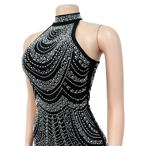 Detail of silver rhinestone wave patterns on a black halter neck sleeveless dress