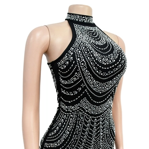 Close-up of the black halter neckline with sparkling silver rhinestones on a dress