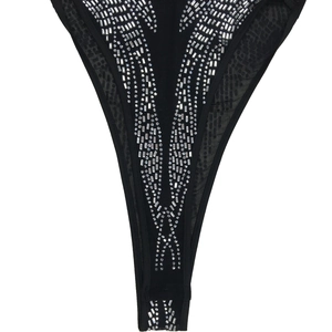 Detail of black mesh jumpsuit featuring leopard pattern with silver rhinestone accents