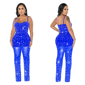 Detailed view of navy blue mesh jumpsuit with silver rhinestones and thin straps