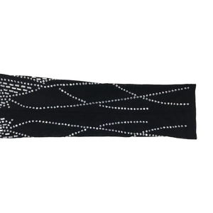 Close-up of black mesh sleeve with sparkling silver rhinestones in wave patterns