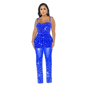 Detail of blue rhinestone mesh jumpsuit featuring slim straps and a sparkling finish